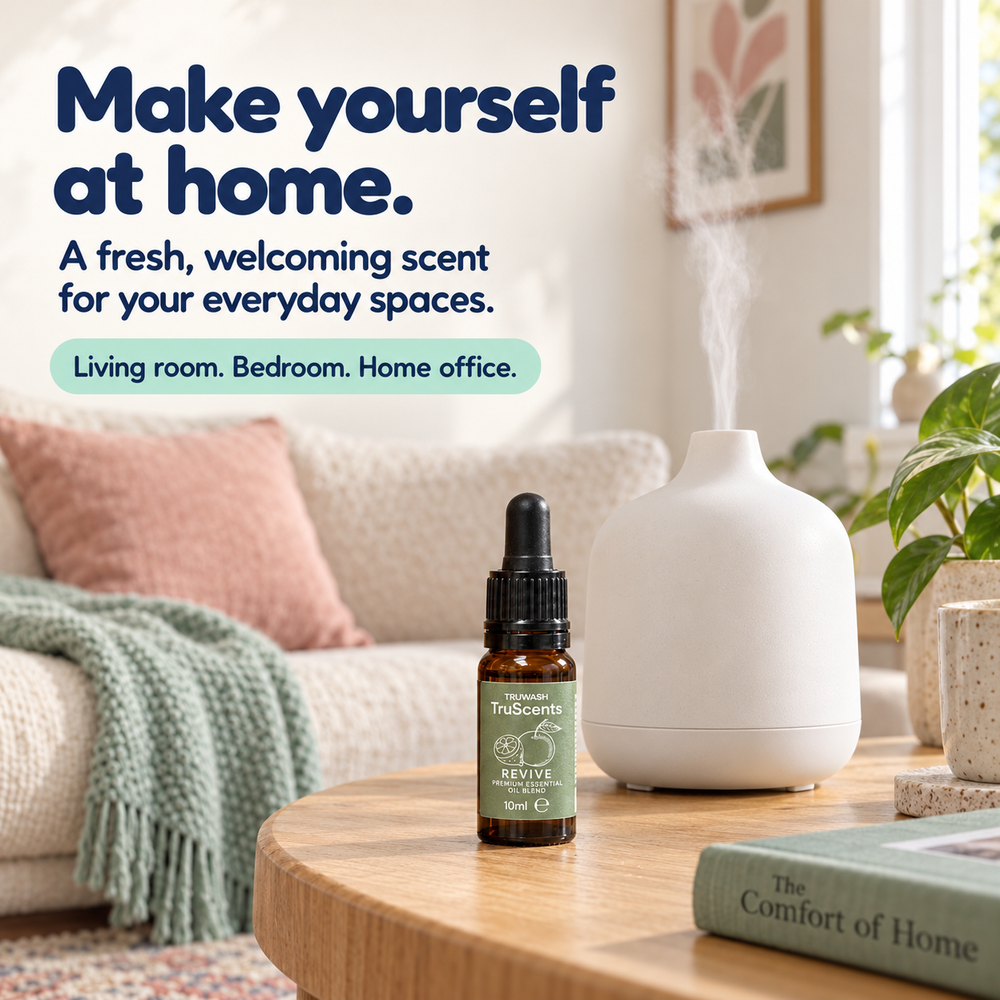Revive essential oil beside a diffuser in a living room with pink and mint furnishings.