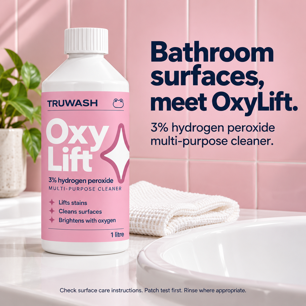 OxyLift bottle beside a bathroom sink with a pink cleaning cloth